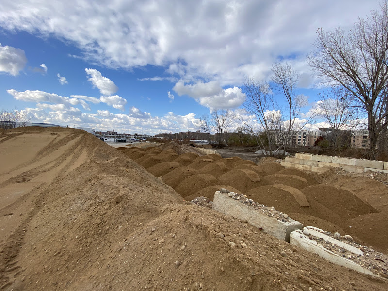 Two Trucks Near Soil Pile